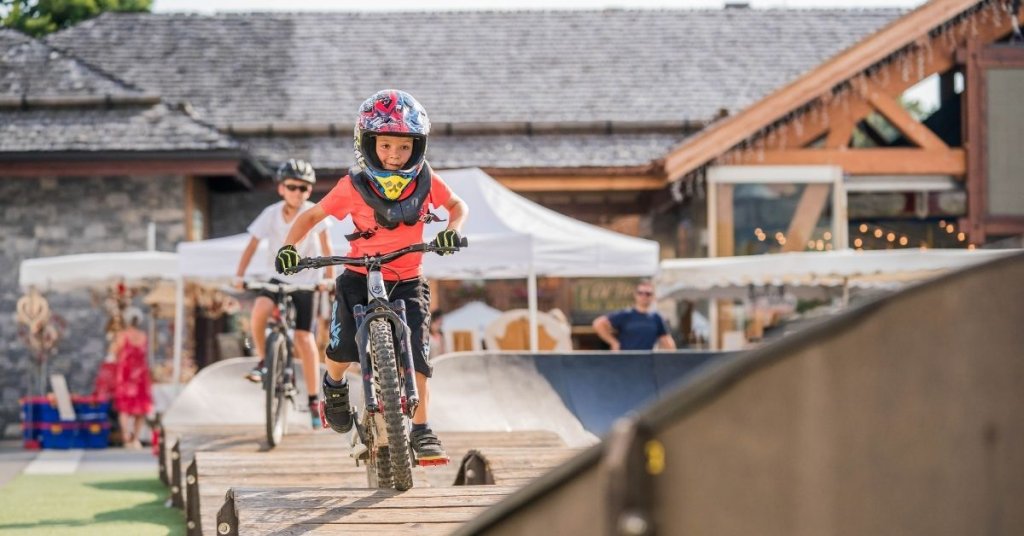 Two kids cycling on a bike track